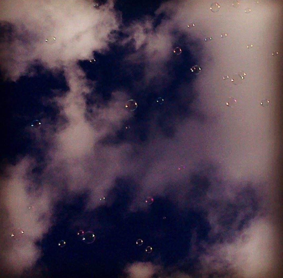 Seifenblasen am Himmel vor Schäfchenwolken